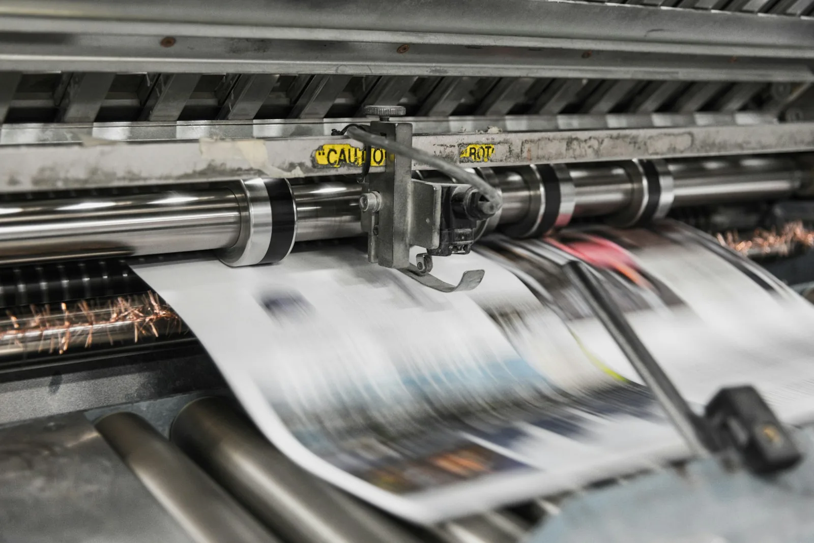 Newspapers running off a printing press